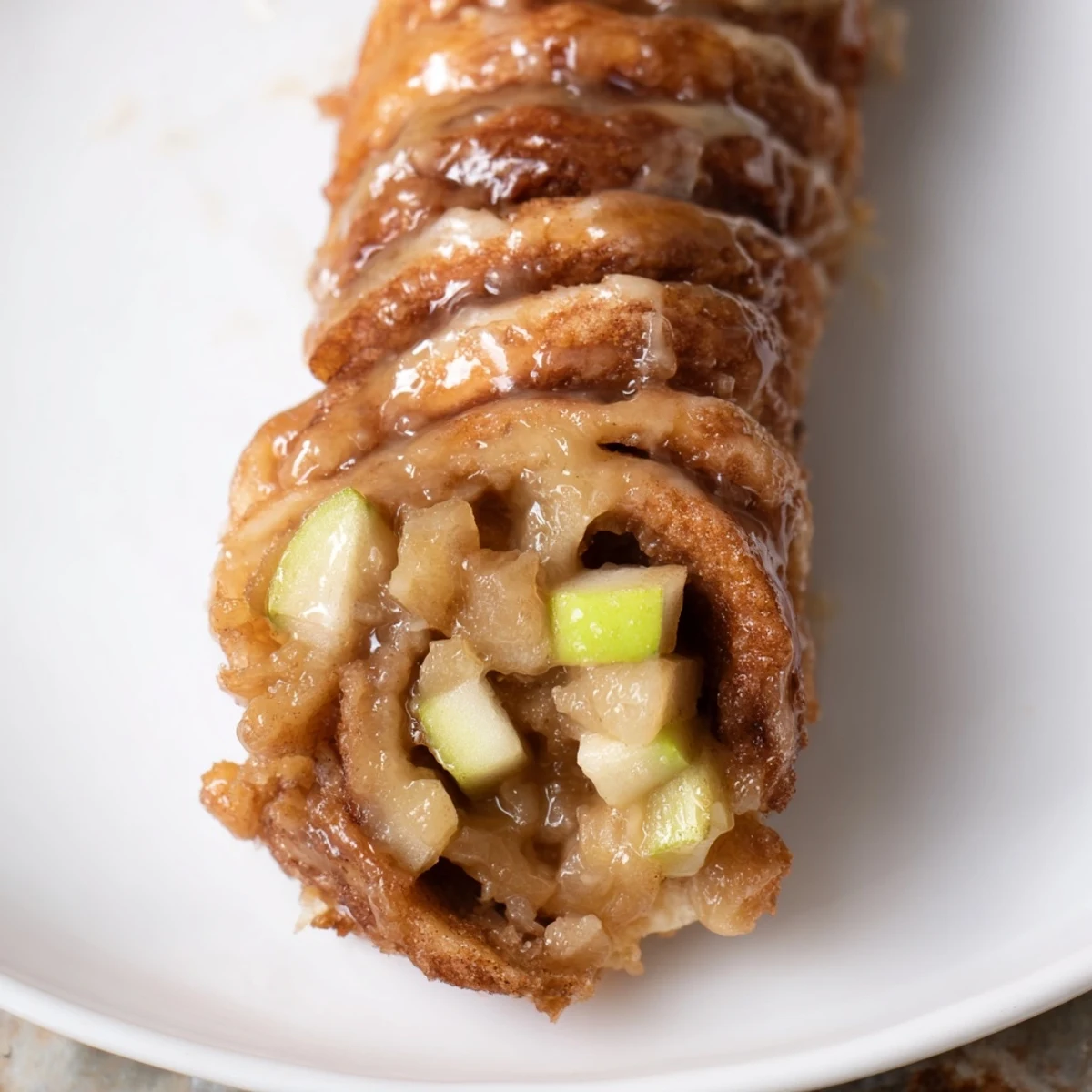 Warm German Apple Fritter Rolls glistening after baking, ready to be coated in cinnamon sugar.