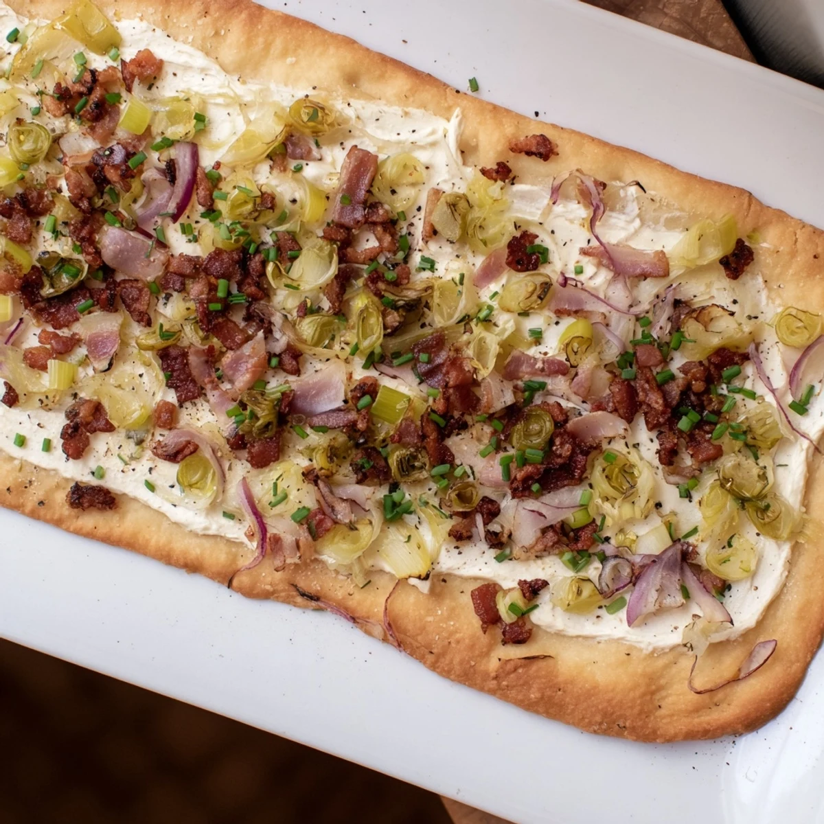 A close-up of the delicious Sheet-Pan Flammkuchen flatbread with visible textures and a delightful aroma.