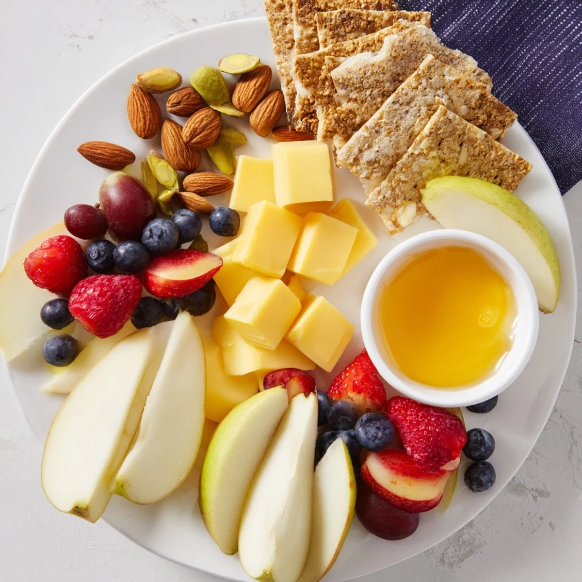 A vibrant Bears Honey Pot Board with fresh fruit, cheeses, nuts, and a central pot of honey.