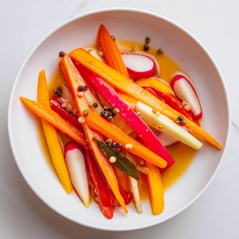 Crisp Quick Pickled Veggie Sticks, a colorful assortment, submerged in a clear, flavorful brine.