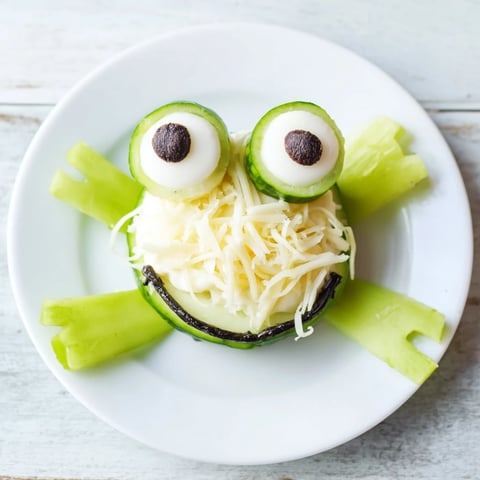 Frog Pond Snack Tray with mozzarella frogs, blueberries, grapes and veggies on a platter.