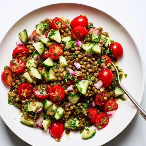 A close-up of a colorful lentil salad, ready to enjoy with a tangy, flavorful vinaigrette.